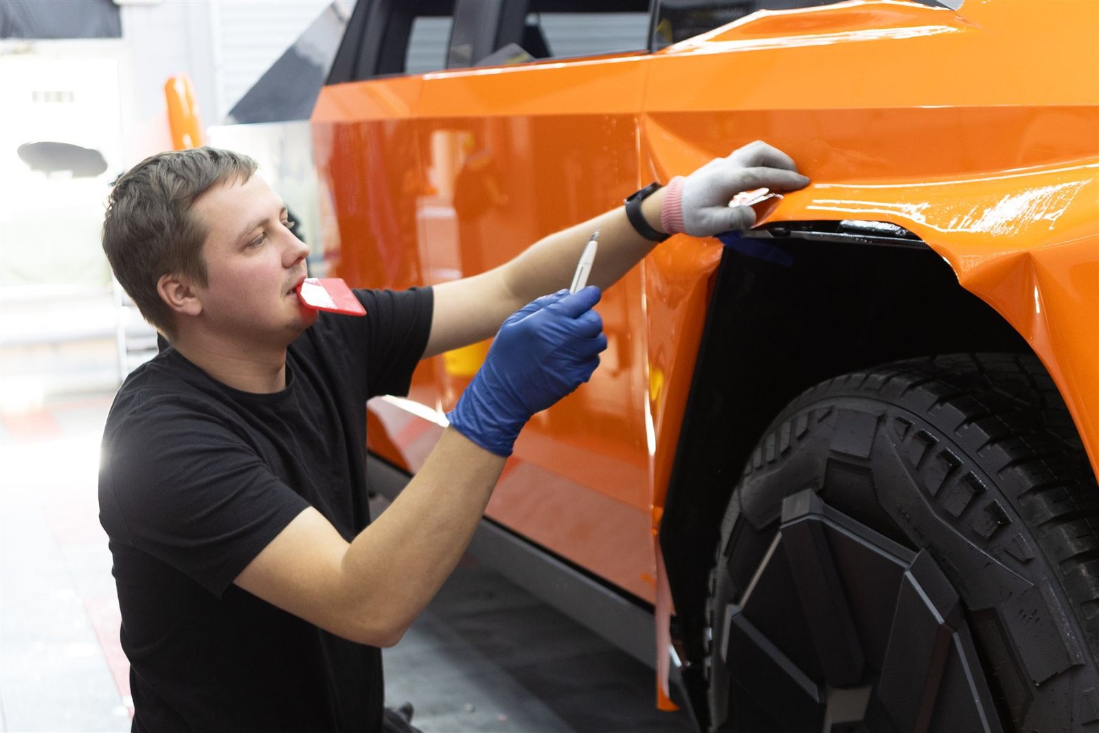 Installing orange PPF on a Cybertruck