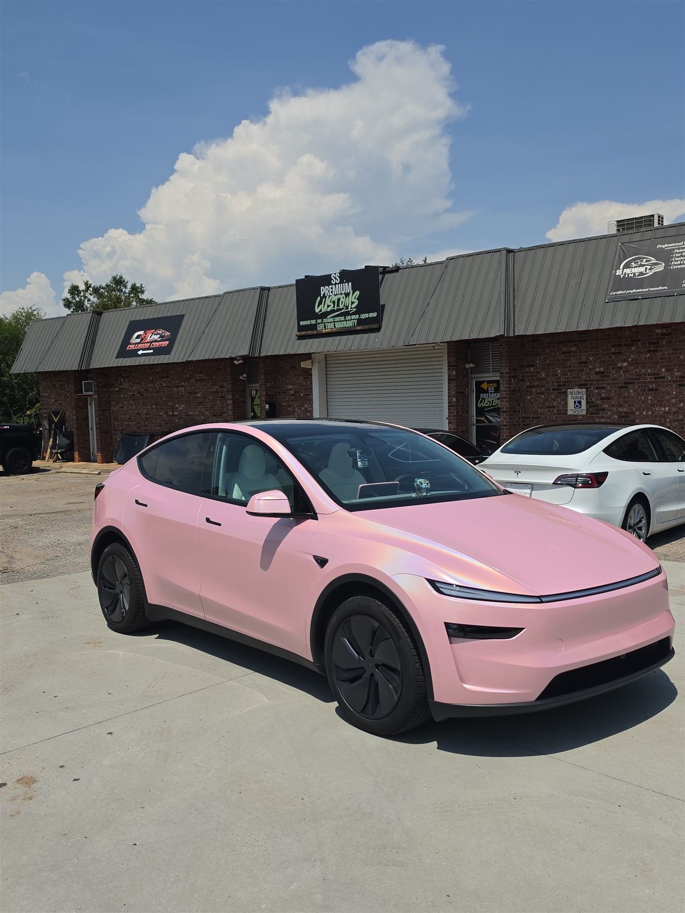 Pink Tesla Model Y parked in front of SS Premium Customs